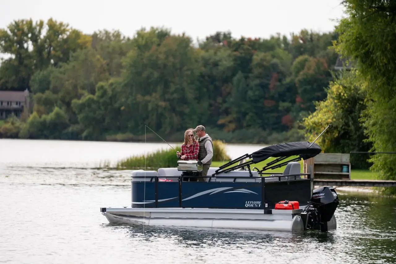 Two anglers aboard a Leisure Quest Fish on a small lake