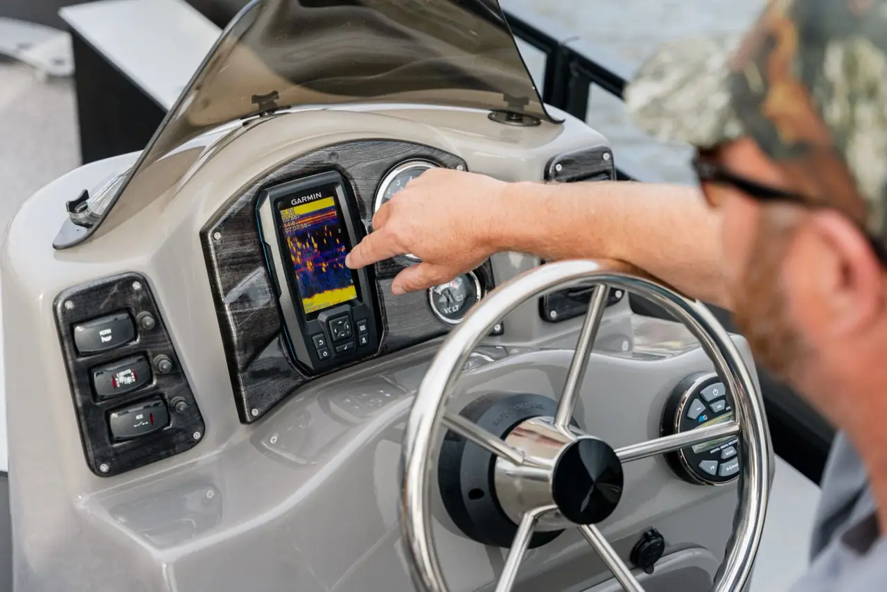 Captain at the fiberglass helm with a Garmin fish finder