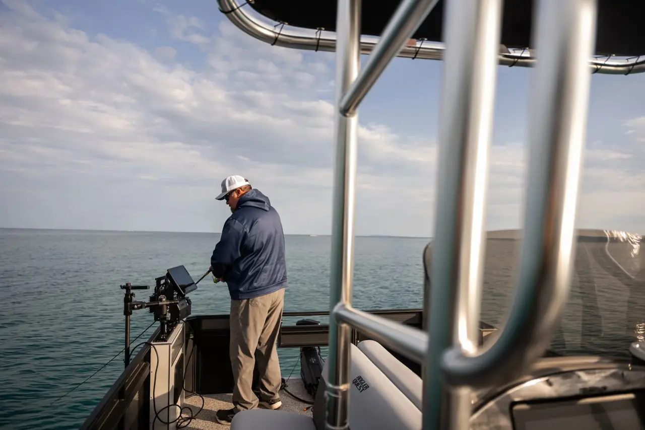 Angler fishing at the bow, seen from under the T-top