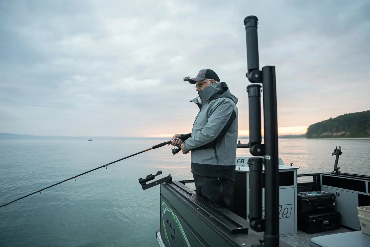 Angler casting from the stern beside the workstation