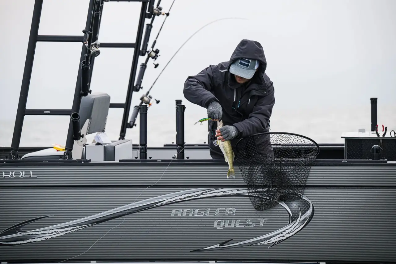 Netting a walleye over the side of a Pro Troll