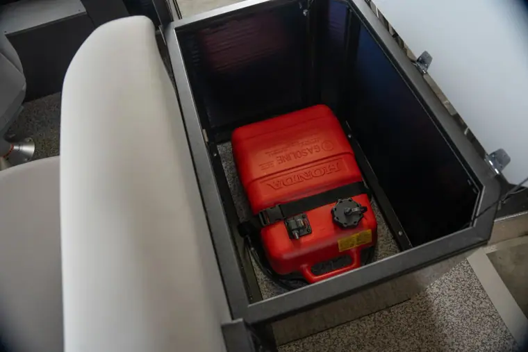 Portable fuel tank in its rear storage compartment