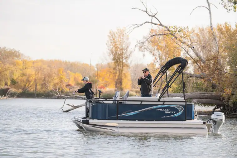 Two anglers casting from a 14-foot Panfish in fall color